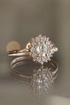 a close up of a diamond ring on a table