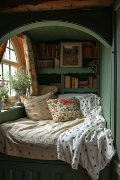 a window seat with pillows and blankets on it