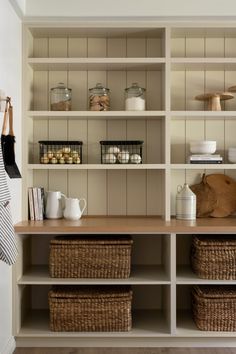 the shelves are filled with baskets and items to store for guests or family members in their home