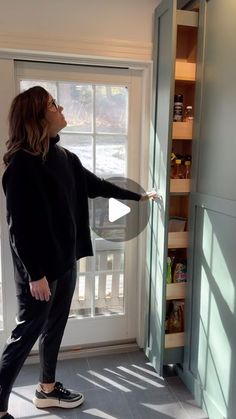 a woman standing in front of a door opening