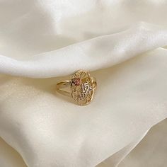 a gold ring sitting on top of a white cloth