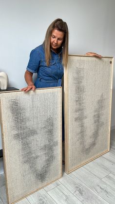 a woman is holding up two pieces of fabric