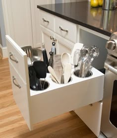 an appliance drawer is open to show the kitchen utensils in it