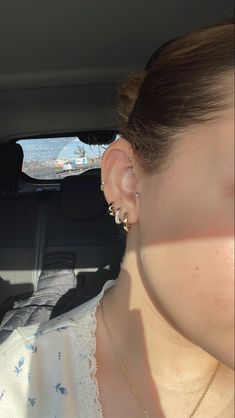 a woman in a car with her ear hanging out the window