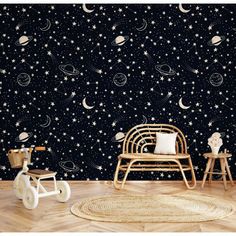 the space themed wallpaper in this children's room is perfect for any child's bedroom