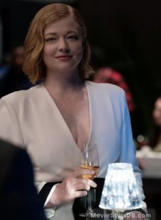 a woman holding a wine glass in her hand