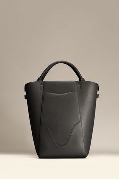 Experience modern simplicity with the Marina Bucket, embodying the dynamic spirit of city-living. Crafted from responsibly sourced Italian top grain leather, this sleek and lightweight bag complements any outfit. It features a central compartment that accommodates up to a 14" laptop, and can be worn as a handbag or shoulder bag. Plus, includes a detachable leather zip pouch for those spontaneous moments on-the-go. Black Bucket Bag, Leather Work Bag, Leather Zip Pouch, Quick Coffee, Everyday Handbag, Laptop Tote, Lightweight Bag, City Living, Leather Work