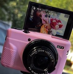 a pink camera sitting on top of a table