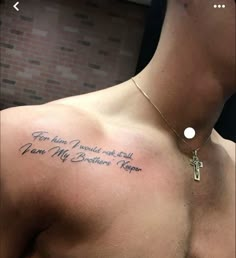 the back of a man's chest with a cross on it and an inscription that says