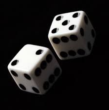 two white dices with black dots on them are sitting side by side in the dark