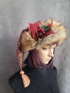 SIZING  The short hats fit average heads of 22 to 23 inches and have a fur pom pom, and the mid-length hats fit 23 to 24 inch heads and all have tassels for the pom.     These hats are made from a gorgeous rich cranberry brocade fabric. It has gold and black stitching throughout it with a big bold pattern. The patterns will vary from hat to hat, and these hats are not lined.     The short hats have a fur pom pom that matches the brim. The brims are cut generously and need to be cuffed down so th Whimsical Winter Hat With Short Brim, Winter Hat With Feather Trim, Whimsical Winter Cap Mini Hats, Winter Festival Top Hat With Curved Brim, Whimsical Red Winter Hat, Adjustable Winter Hats For Costume Events, Winter Festival Top Hat With Short Brim, Adjustable Hats For Winter Costume, Whimsical Brimmed Winter Costume Hats And Headpieces