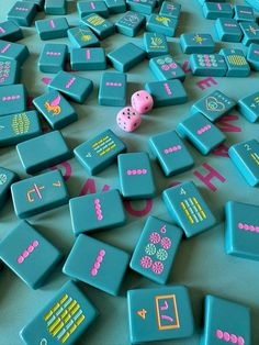 a large number of blue and pink dominos on the ground with one dice missing