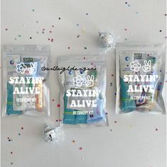 three bags of toothpaste sitting on top of a table with confetti