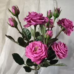 a vase filled with pink flowers on top of a table