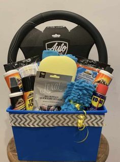 a blue bucket filled with cleaning products and other items