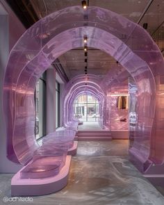 the inside of a building with purple walls and benches