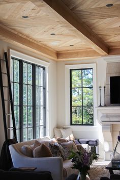 a living room filled with furniture and a flat screen tv mounted on the wall next to a fire place