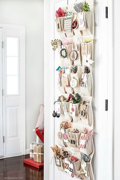 an instagramted photo of a christmas tree hanging on a door with stockings and ornaments