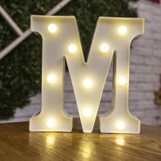 the letter m is lit up with lights