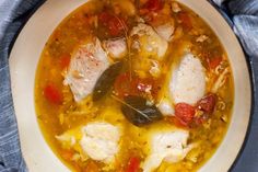 a white bowl filled with chicken and vegetable soup