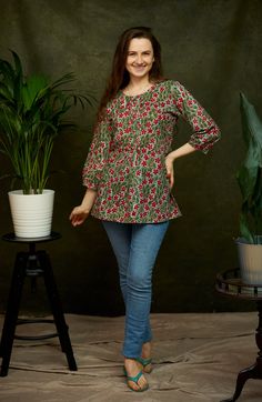 "🌷  RED JASMINE Add a splash of colour to your wardrobe with our Red Jasmine Tunic in vibrating hand block prints. Red Jasmine was created for a comfortable loose fit, and decorated with pintuck detailing at the front and back. Sizings Size S:   Shoulders 38cm - 14.9\" Bust  98cm - 38.5\" Length approx. 70cm - 27.5\" Size M:   Shoulders 39cm - 15.3\" Bust  100cm - 39.3\" Length approx. 70cm - 27.5\" Size L:   Shoulders 40cm - 15.7\" Bust  106cm - 41.7\" Length approx. 70cm - 27.5\" Size XL:   S Bohemian Green Printed Shirt, Casual Summer Festive Kurta, Green Bohemian Printed Shirt, Traditional Floral Print Tunic Top, Casual Cotton Printed Peasant Top, Casual Printed Cotton Peasant Top, Traditional Floral Print Top For Vacation, Casual Cotton Tops For Festive Occasions, Traditional Floral Print Vacation Tops