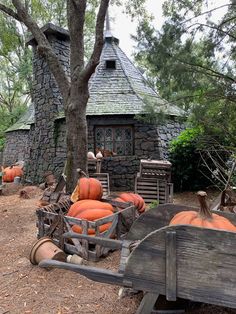 pumpkins and other items are sitting in front of an old stone house