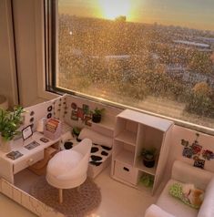 a miniature living room is shown in front of a window with the sun going down