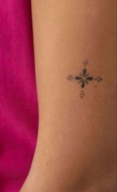 a woman's arm with a small tattoo on the left side of her body