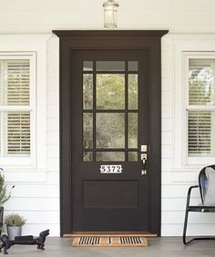 a black front door on a white house