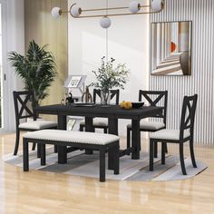 a dining room table with four chairs and a bench