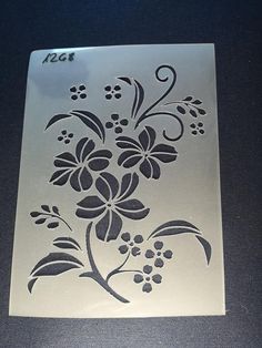 a stencil with flowers on it sitting on top of a black countertop