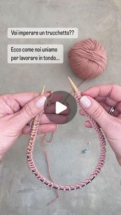 two hands holding yarn and crochet hooks in front of a ball of yarn