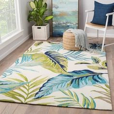 a living room area with a rug, chair and potted plant