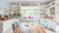 a living room filled with furniture and lots of windows