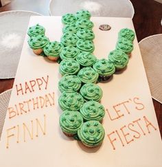 cupcakes are arranged in the shape of a cactus