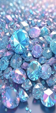 many blue and pink diamonds are scattered together on the ground with water droplets around them