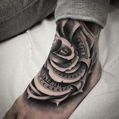 a man's foot with a tattoo on it