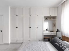 a bedroom with white closets and a large bed in it's center area