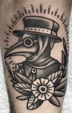 a black and white tattoo with a bird wearing a hat