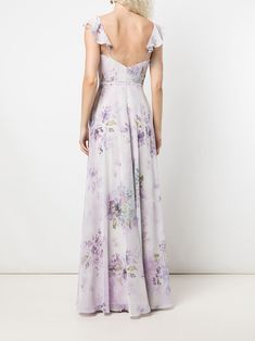 the back of a woman wearing a purple floral print dress