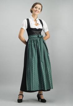 Black Dirndl with apron and white blouse 3 pc set Long Dirndl Amber with apron and blouse for women in black. The classic dirndl impresses with many lovely details. The bodice is finished with hand-made relief decorations. The classic bodice hooks are provided with a chain lock. The ideal combination partner for all trendy and traditional aprons. German Outfits Women, Traditional French Clothing, Traditional Irish Clothing, Dirndl Dress Traditional, German Traditional Clothing, Traditional German Clothing, Drindl Dress, German Traditional Dress, Traditional Aprons