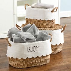 three baskets that have towels in them on the floor