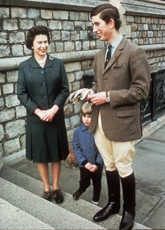 a man and woman standing next to a little boy