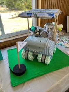 a cake made to look like a car with stuffed animals in it and an umbrella