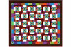 a colorful quilt with squares on the front and back, in brown wood framed print