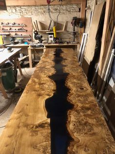 a table that is made out of wood and has water running down the side of it