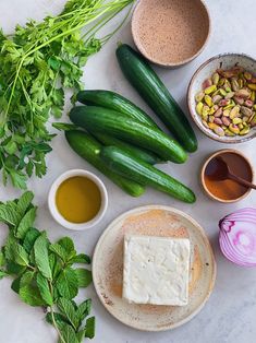 cucumbers and other ingredients are arranged on a table