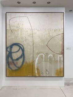 an abstract painting on display in a white room