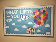 a bulletin board that says what lifts you up? with a house and balloons in the sky