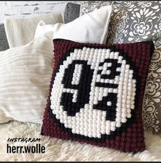 a pillow made to look like the face of an anime character is shown on a bed